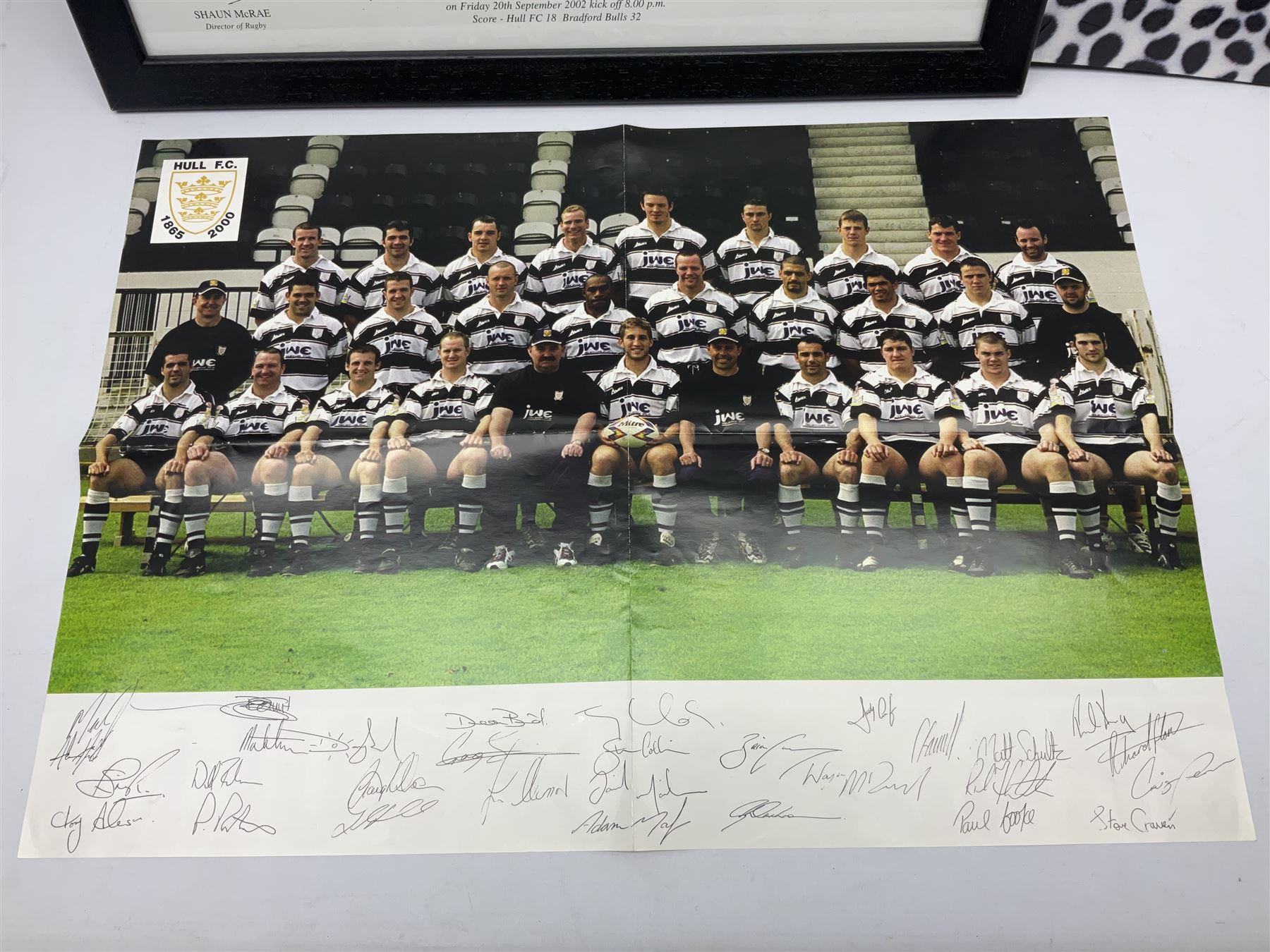 Hull F.C. memorabilia; Clive Sullivan 1986 memorial game programme, Open Evening 1994 programme with multiple player signatures, 'Old Faithful' 45rpm record, Wembley rosettes, 2000 team poster with facsimile signatures, framed print 'Farewell to the Boulevard 1895-2002', fully signed team photograph, various booklets, CD, DVD etc; and a folder containing the Merlin Rugby League card collection