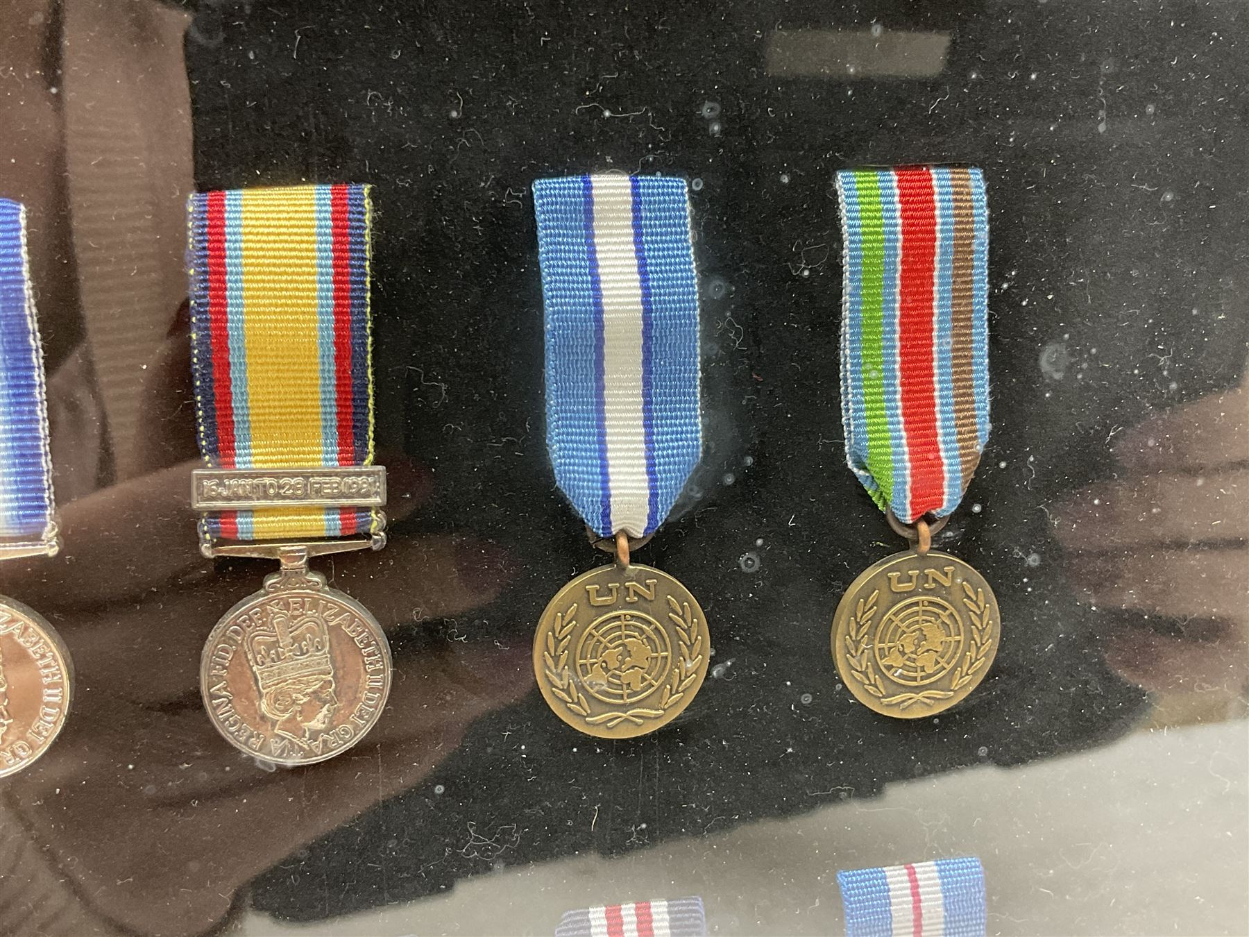 Limited edition large framed display board with sixty half-size copies of British Gallantry and Campaign Medals produced by Danbury Mint; all with ribbons and associated booklet