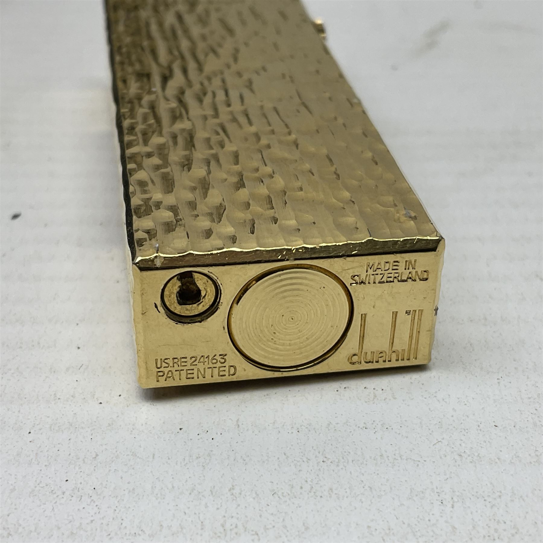 Dunhill gold plated lighter with textured bark effect decoration, in fitted case