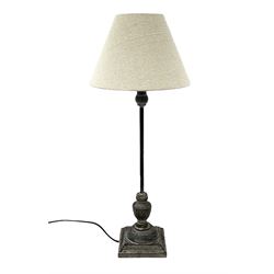 Table lamp, with a thin central stem upon a square stepped base, natural linen shade