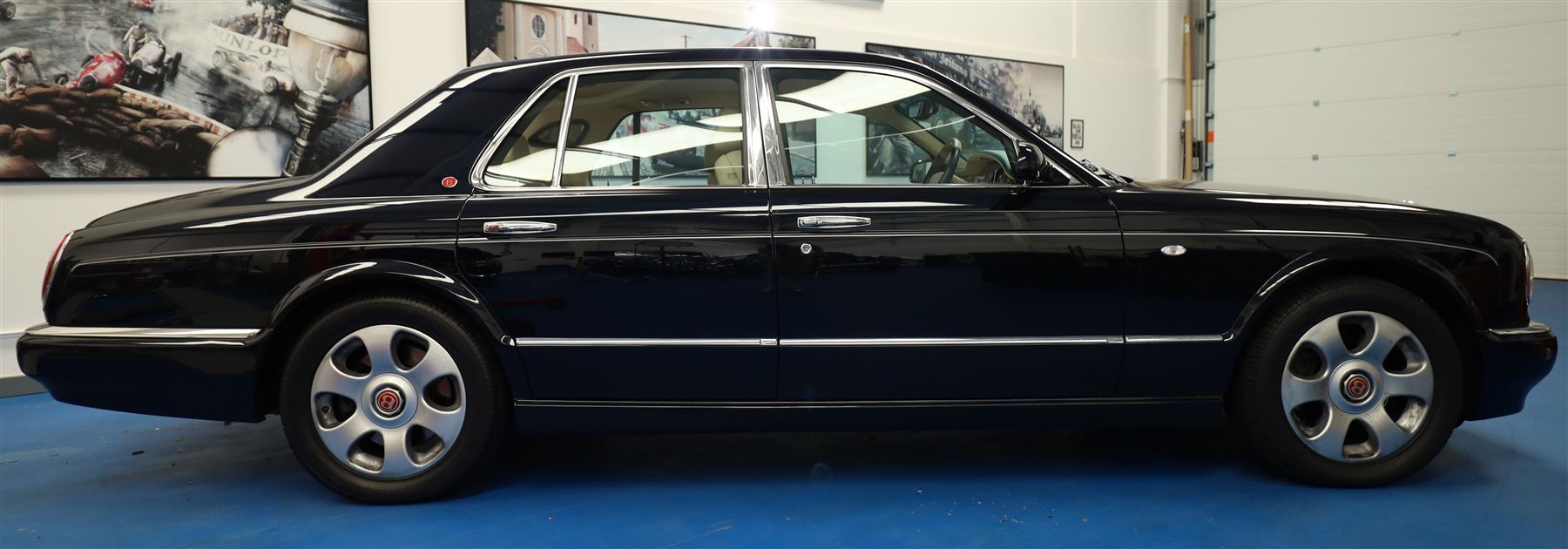 2001 Bentley Arnage Red Label Saloon

Registration: BU51 TGX
Engine: 6.75-litre turbocharged V8 petrol
Transmission: Automatic
Odometer reading: 39,942 miles
Colour: Black Sapphire metallic
Interior: Magnolia leather with burr walnut veneers
Previous owners: 3
V5C: Present
Service history: Good service records

An exceptional Bentley Arnage Red Label Saloon, finished in Black Sapphire metallic, a very dark blue, with a Magnolia leather interior, contrasting dark blue carpets and extensive burr walnut veneers. The car displays an odometer reading of approximately 39,942 miles.

The Arnage Red Label combined Bentley’s renowned 6.75-litre turbocharged V8 engine with automatic transmission, delivering effortless performance in a traditionally appointed luxury saloon. The model is distinguished by its imposing proportions, characteristic Bentley radiator grille and finely crafted interior.

Presented in excellent condition throughout, the bodywork and metallic paint finish appear particularly well preserved, complemented by clean brightwork and the correct Bentley alloy wheels. The engine bay is also notably well detailed.

The interior presents exceptionally well, retaining its Magnolia leather upholstery, polished burr walnut veneers, original factory instrumentation and switchgear. The leather displays only light creasing consistent with careful use.

The car has had three previous owners and is accompanied by good service records.

Features

• 6.75-litre turbocharged V8 petrol engine
• Automatic transmission
• Black Sapphire metallic paintwork
• Magnolia leather interior
• Contrasting dark blue carpets
• Burr walnut veneers
• Electrically adjustable front seats
• Air conditioning
• Factory instrumentation and switchgear
• Bentley alloy wheels
• Right-hand drive
• Odometer reading of approximately 39,942 miles
• Three previous owners
• Good service records
• V5C present

This vehicle forms part of the Estate of the Late John Sills and is offered for sale by the Executors, confirming a genuine reason for sale.