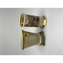 Two 19th century porcelain spill vases, in the Derby style, the first example with twin mask handles and raised upon three paw feet, decorated with a landscape panel and gilt scrollwork, H11cm, the second example decorated with a continuous landscape band and beaded detail, H11cm
