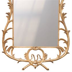 Large metal framed wall mirror, of rectangular form within an ornate openwork frame cast with scrolling foliate decoration and pierced cresting, finished in a gilt tone