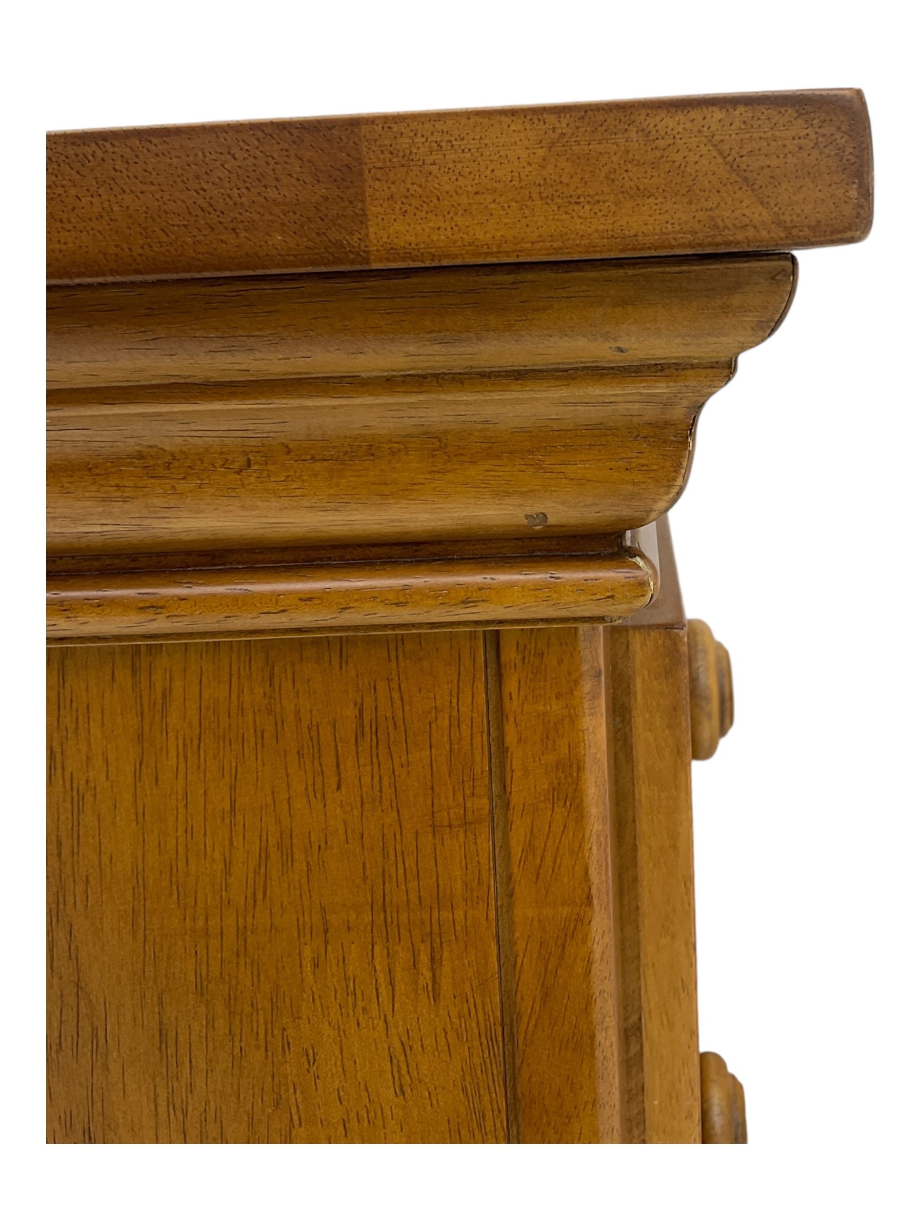 Pair of contemporary cherry wood bedside chests, rectangular top and projecting moulded cornice over three drawers, on plinth base with shaped apron