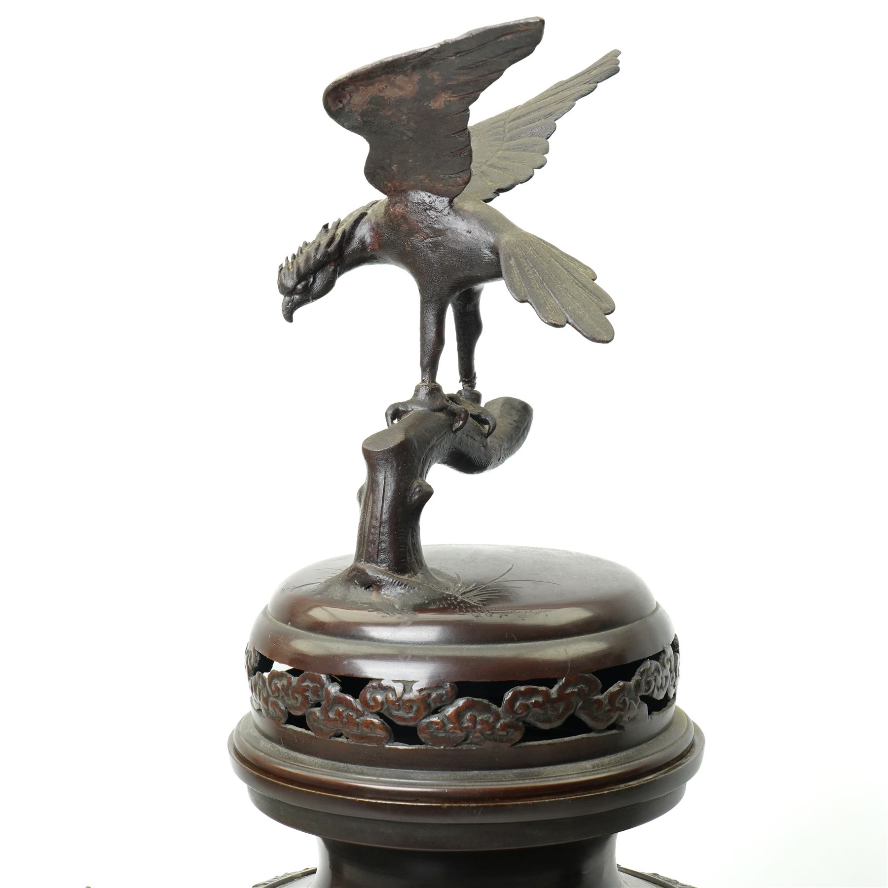 Japanese late Meiji period bronze koro and cover, surmounted by an eagle finial and with bird decoration in high relief to each side, twin elephant trunk handles, bearing indistinct character signature to one side, H82cm