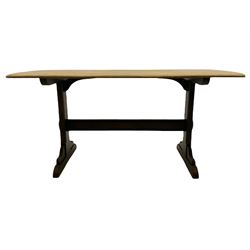 Ercol oak dining table, rectangular end supports joined by stretcher on shaped sledge feet