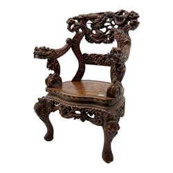 Chinese heavily carved hardwood armchair, serpentine seat