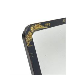 Early 20th century Chinoiserie black lacquered mirror, of rectangular form with rounded upper corners, painted in gilt with traditional landscapes, with easel style support verso 
