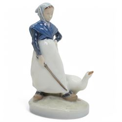 Four Royal Copenhagen figures, including Amager Girl Sewing no. 1314, Boy Whittling no. 905, Girl with Goose no. 528, and Amager Girls Reading no. 1395