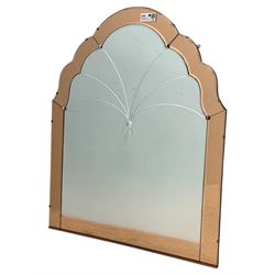 Frameless art deco mirror, scalloped copper tinted border central fan motif, bevelled edges with decorative screw caps