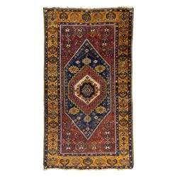 Turkish Anatolian wool rug, central stepped medallion on dark blue lozenge field, red span...