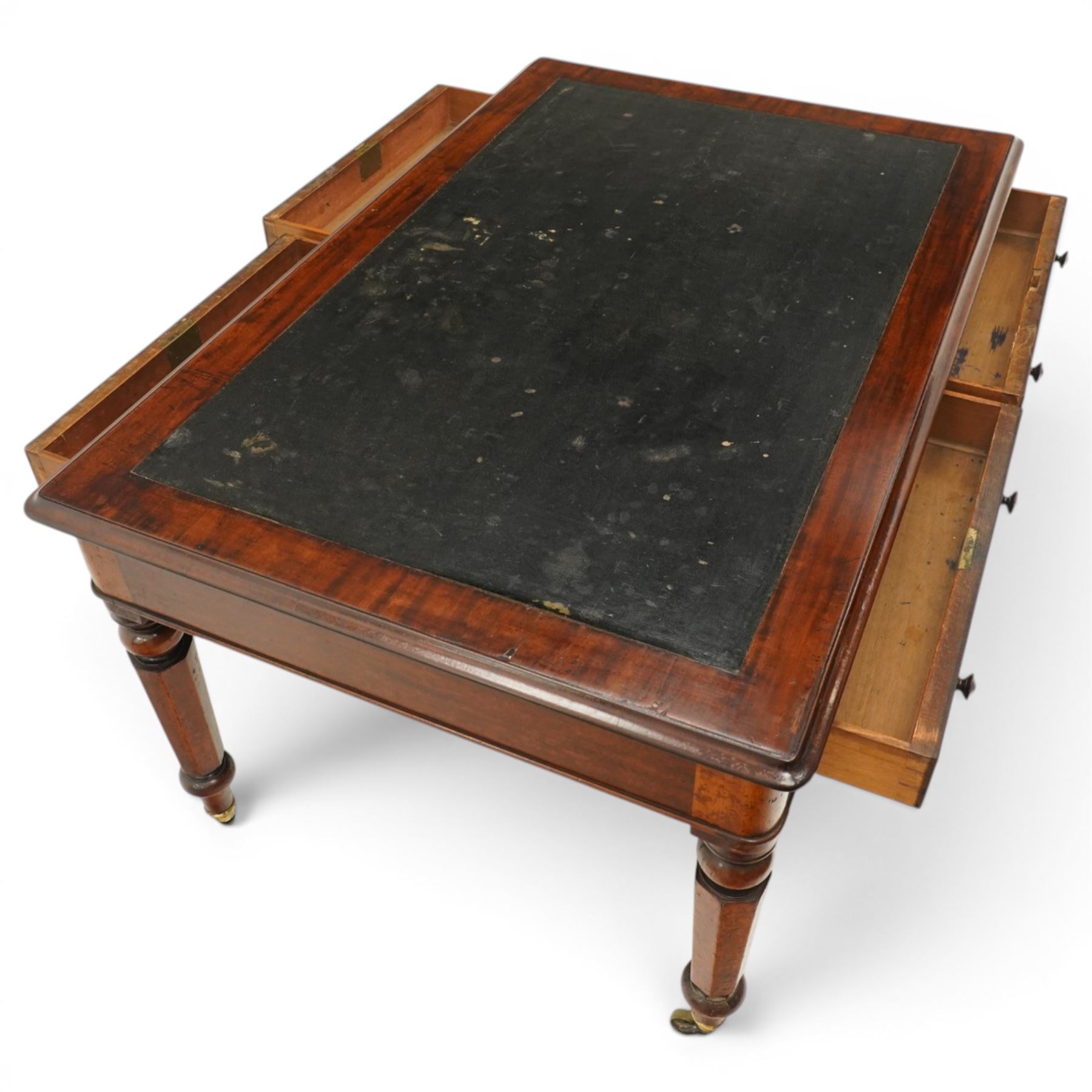 Mid Victorian four drawer mahogany partners' writing table, with leather inset top with moulded edge, with two frieze drawers to either side, on turned supports terminating in castors