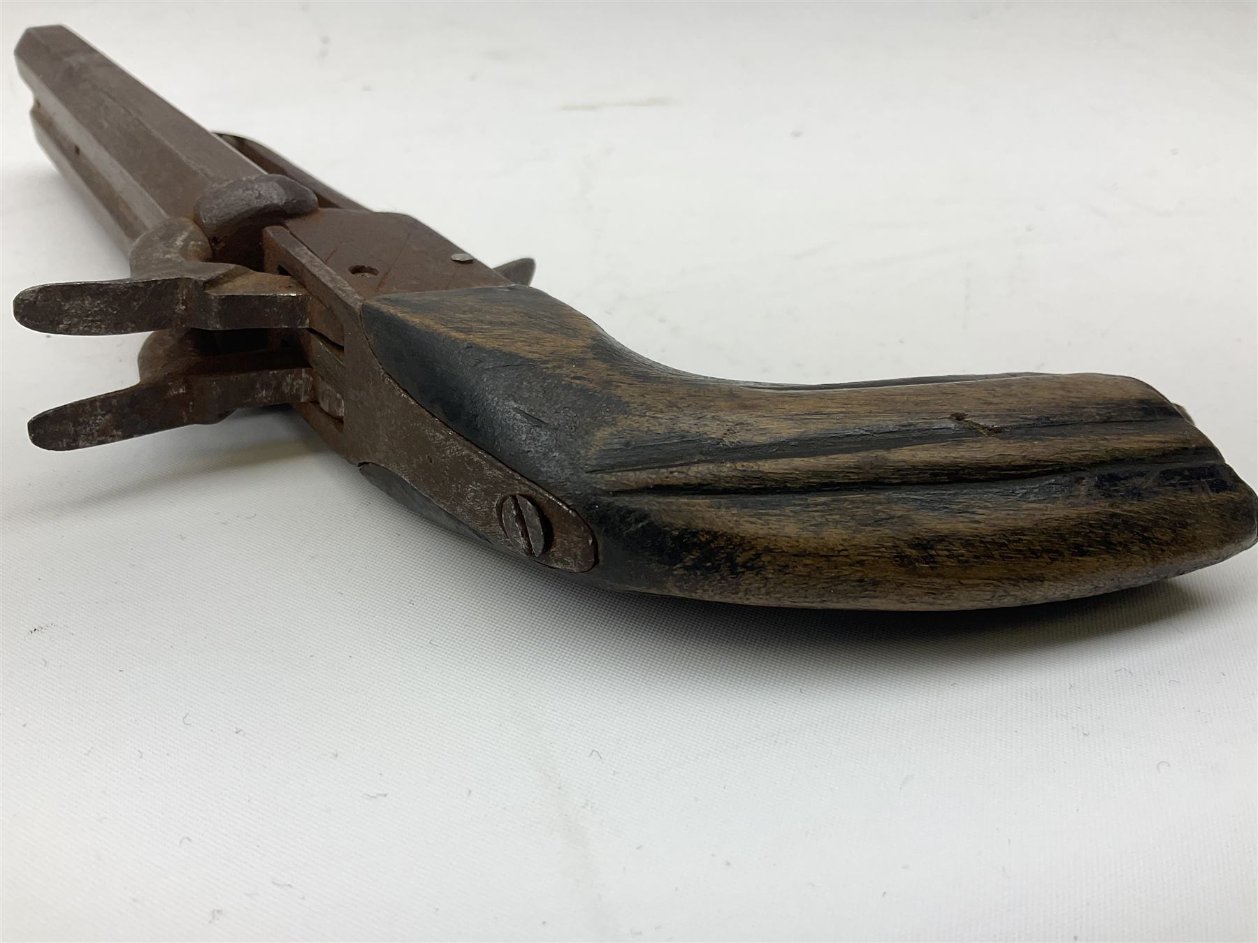 19th century Belgian 9mm side-by-side double barrel pin-fire pocket pistol with 11cm octagonal single block barrel, drop-down triggers and carved walnut stock L22.5cm overall