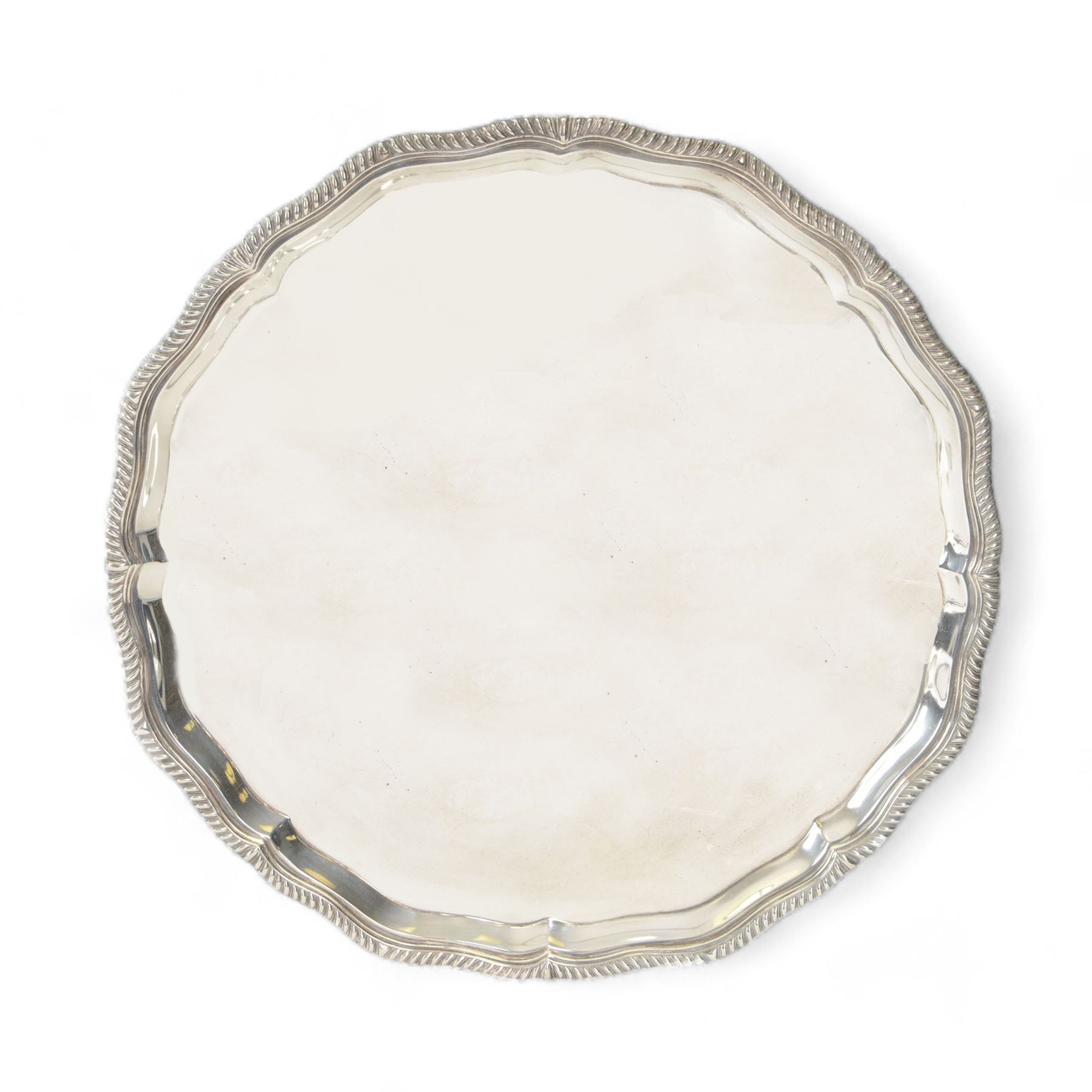 Early 20th century silver salver, of circular form with piecrust and oblique gadrooned rim, hallmarked Manoah Rhodes & Sons Ltd, Sheffield 1932, D36cm