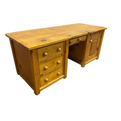 Large pine desk, rectangular top over four drawers, slide and panelled cupboard