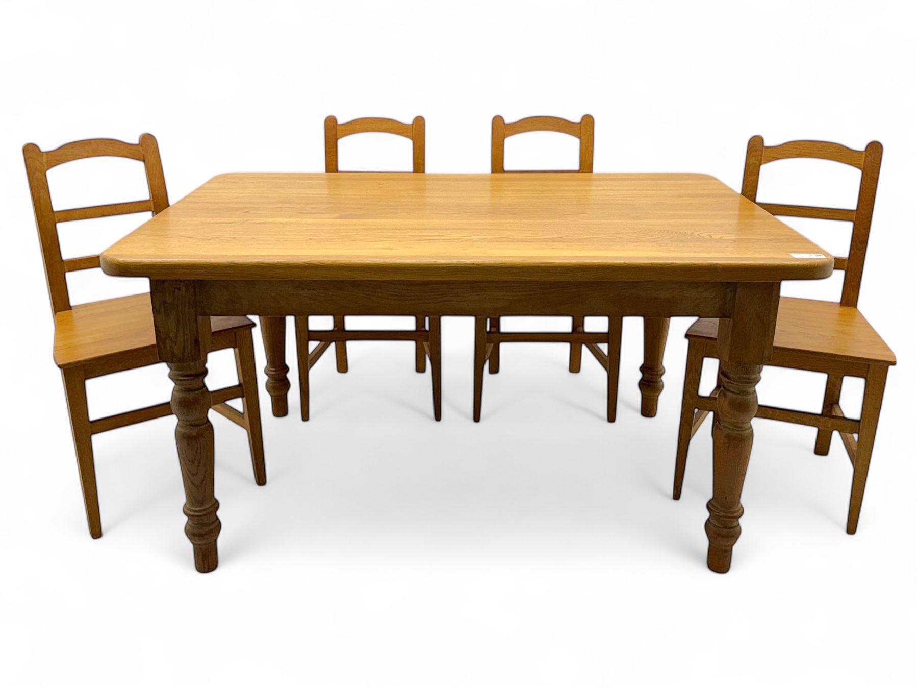 Contemporary light oak farmhouse dining table, and four oak ladder back dining chairs, rectangular top with rounded corners, raised on four turned baluster legs in natural lacquered finish, chairs with three horizontal slats beneath a shaped top rail, solid seat and square section legs united by stretchers