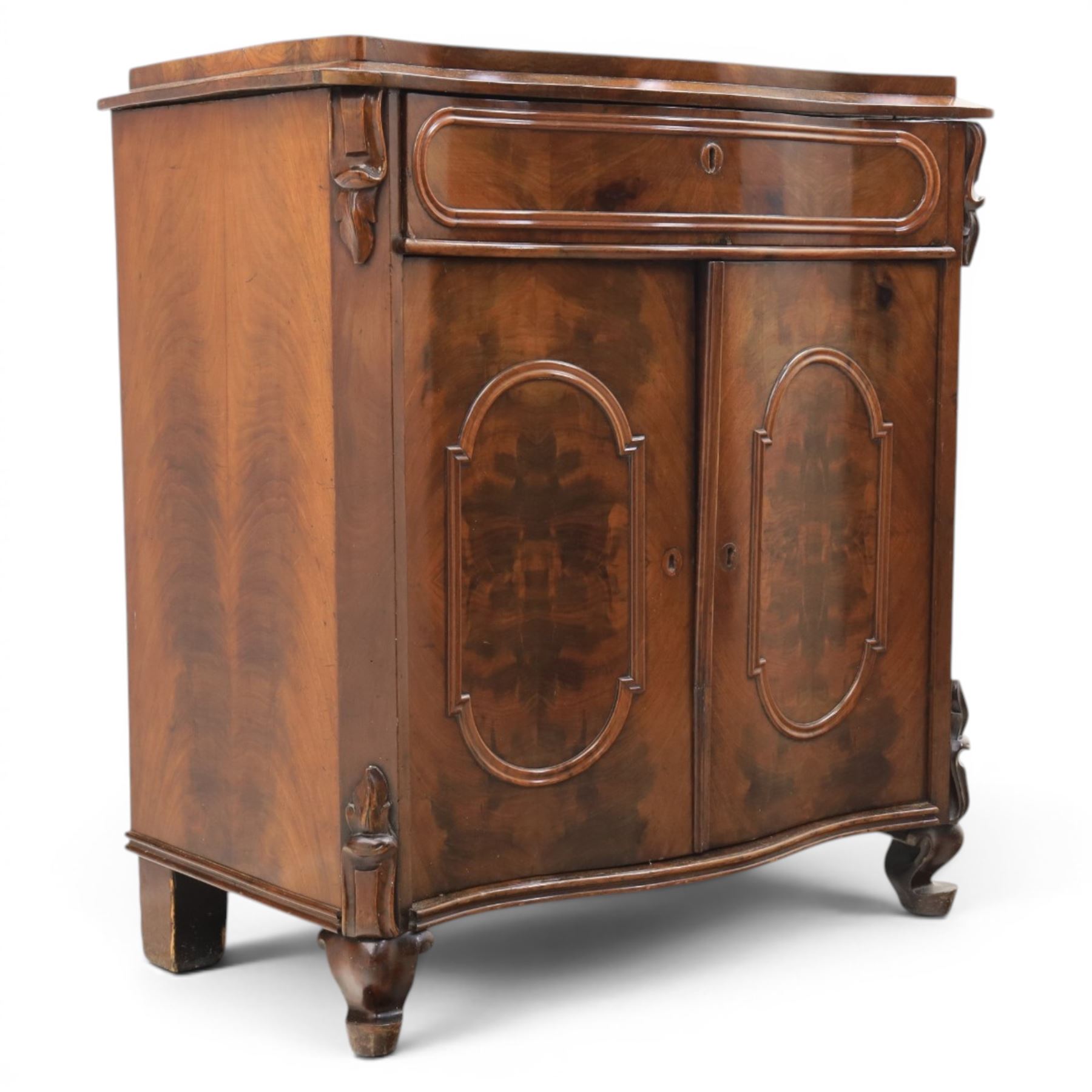 Victorian mahogany chiffonier, with serpentine front and book-matched veneered top, over a frieze drawer and cabinet, raised on pad feet