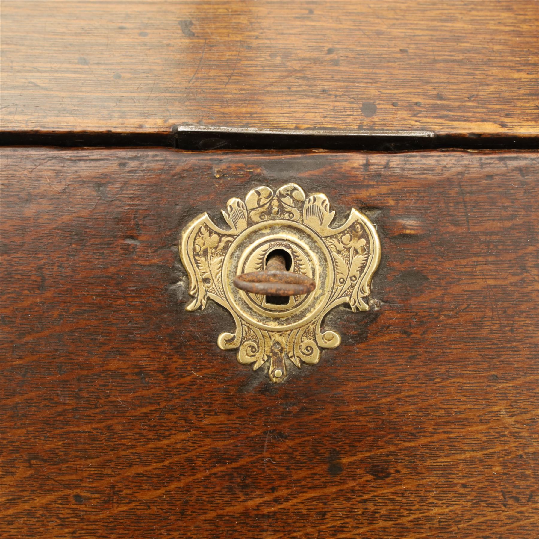 Early 18th century George I oak bureau on original stand, the fall front enclosing an arrangement of correspondence drawers and pigeonholes over central well, fitted with single long drawer below, the shaped apron over cabriole supports with pad feet