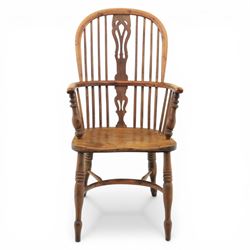 Early 20th century yew wood Windsor armchair, hooped back with spindle supports and shaped pierced central splat, solid seat with shaped edge, turned arm supports, on turned legs united by crinoline stretcher