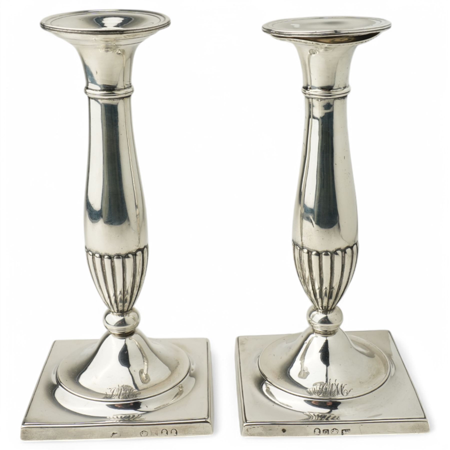 Pair of George III silver candlesticks with baluster stems and square bases, engraved with a monogram H20cm Sheffield 1793 and 1797, one double struck with kings head