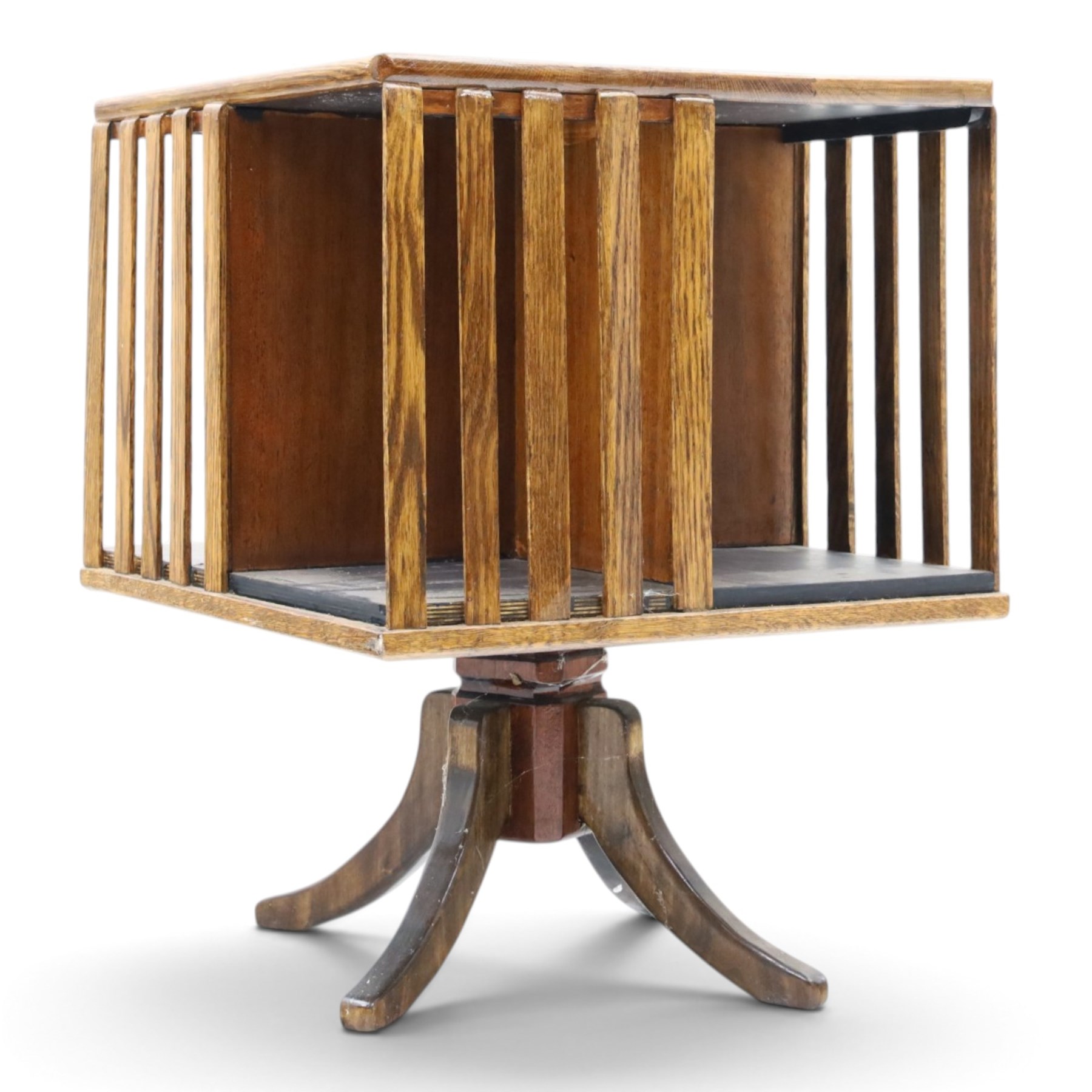 Early 20th century oak revolving bookcase, square top above four divided sections, raised on a revolving base