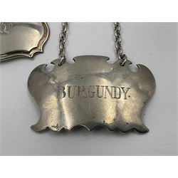 Five modern silver decanter labels, to include two sherry examples, embossed with scrolls and fruits, hallmarked W I Broadway & Co, Birmingham 1991 & 1997, a similar claret example, hallmarked S J Rose & Son, Birmingham 1973, and two plain shaped port and burgundy examples, hallmarked C Robathan & Son, Birmingham 1997 and A Haviland-Nye, London 1968