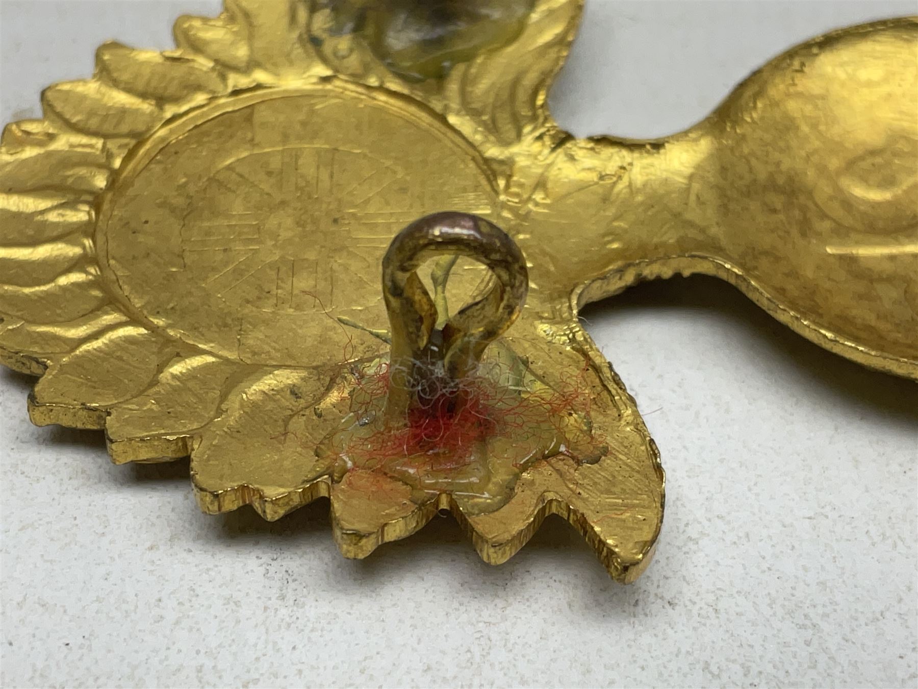 WW1 25th Battalion (Frontiersmen) City of London Royal Fusiliers Cap Badge; gilt brass fused grenade with 25 to the centre; circular section to the flames with red enamel cross and enamel union flag with GOD GUARD THEE to the centre; lower scroll with FRONTIERSMEN; two lug fittings verso.