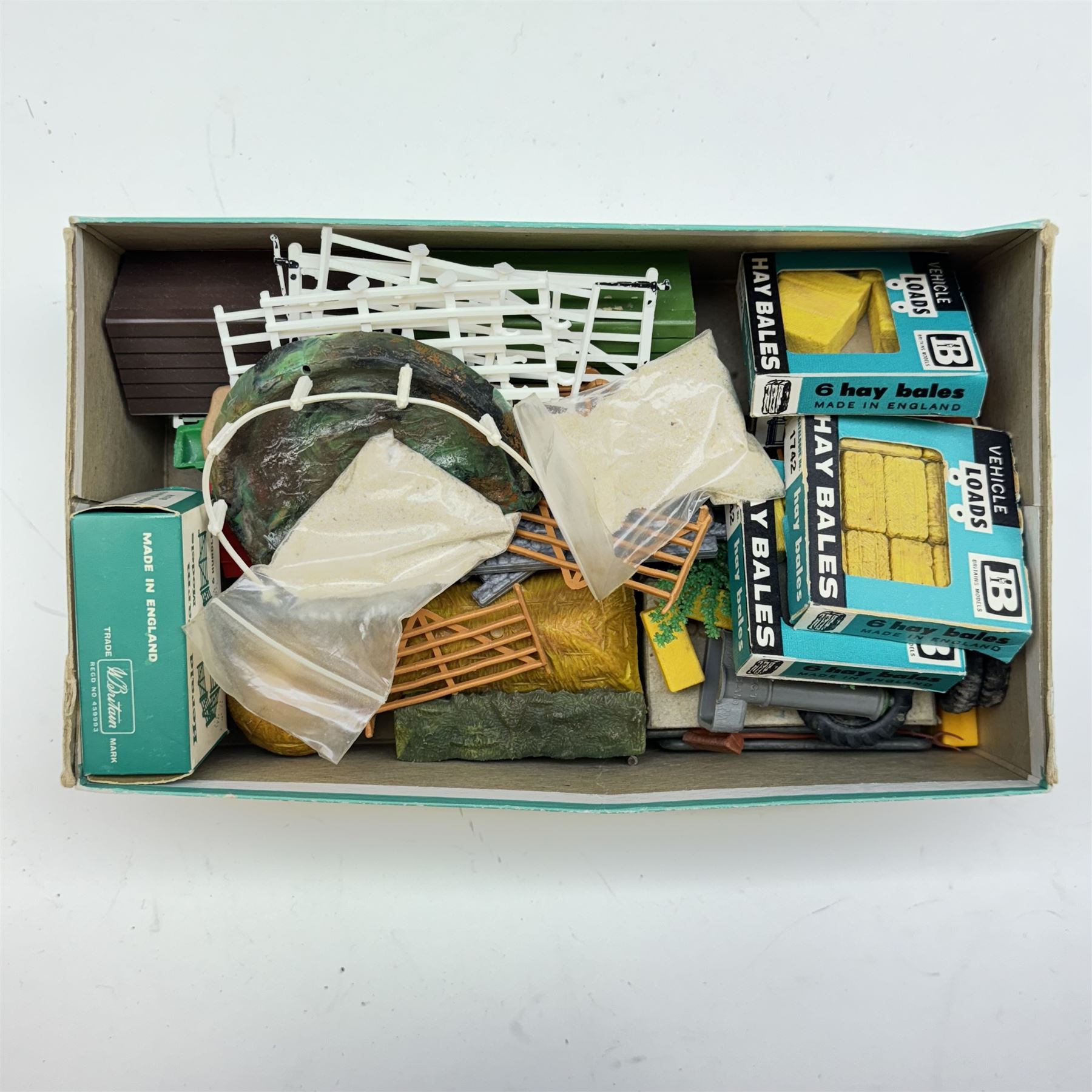 Britains 1:32 scale farm implements, vehicles and figures,  comprising 9563 Hay Baler, 9539 Seed Drill, 9534 Disc Harrow, 9537 Acrobat Rake, 9530 Three Furrow Plough, 9547 Horse Box with Horse, 9576 Farm Land Rover, 2078 male Rider with Horse, 9533 Roller, 9538 Vari-Spreader, 9536 Cultivator, three 1742 Hay Bales, 1740 Milk Churns and 1741 Sacks, all boxed, together with trees, walls, buildings and loose vehicles