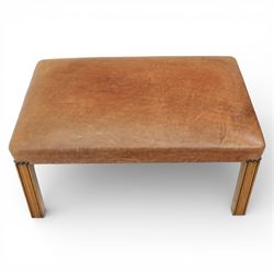Modern tan leather stool, with studded detailing above a reeded stile supports terminating in metal caps
