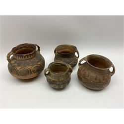 Four Chinese Neolithic pottery vessels, each with twin loop handles to the shoulder and painted geometric banded decoration to the body, three bearing labels for Eskenazi London, tallest H13cm