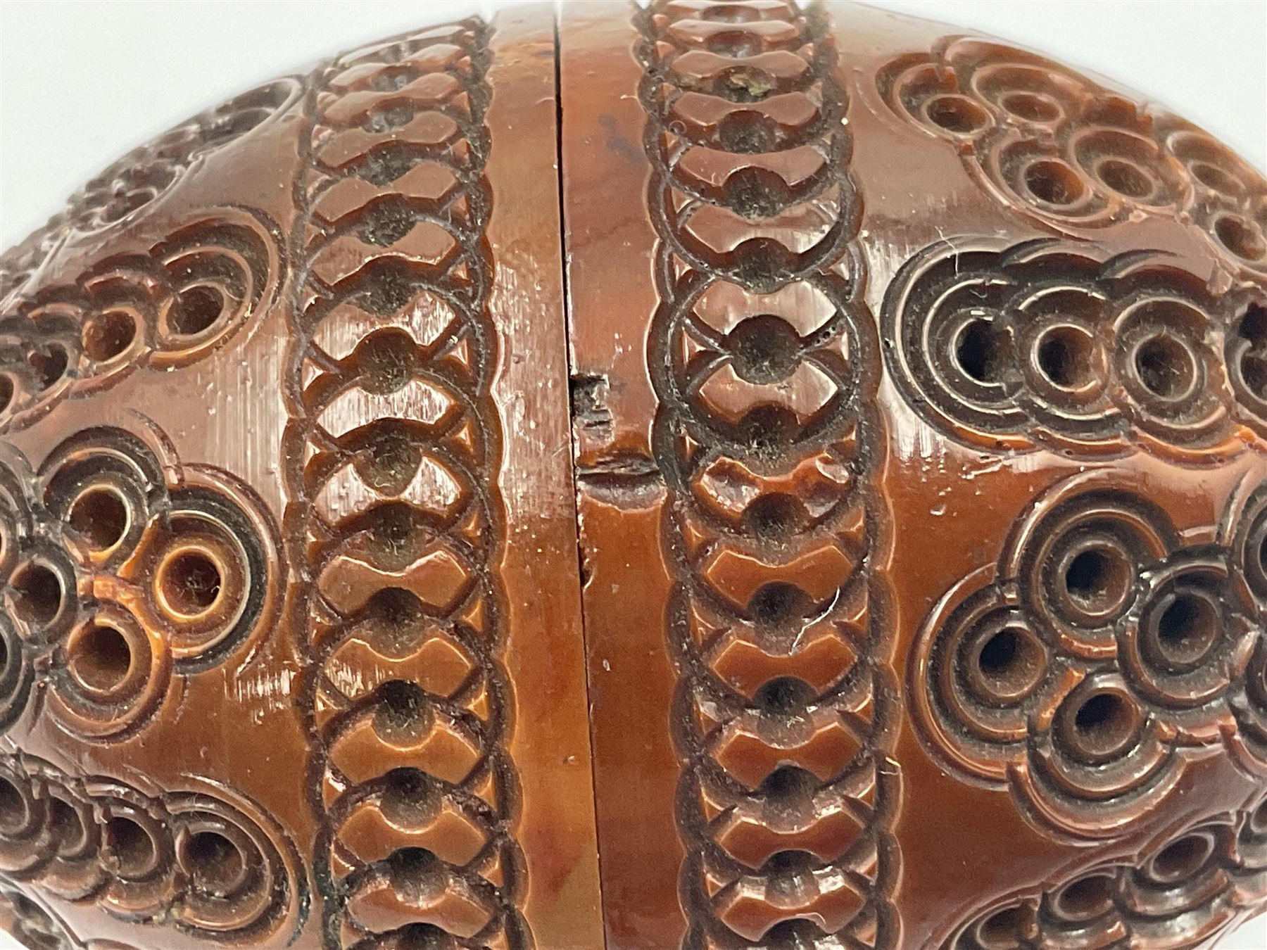 Three 19th century coquilla nut pomanders or flea catchers, two of egg shaped form and the third of barrel from with carved and pierced decoration and screw threaded join, largest H8cm