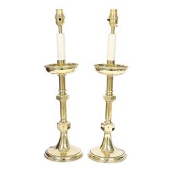 Pair of early 20th century brass alter candlesticks converted to table lamps, each with st...