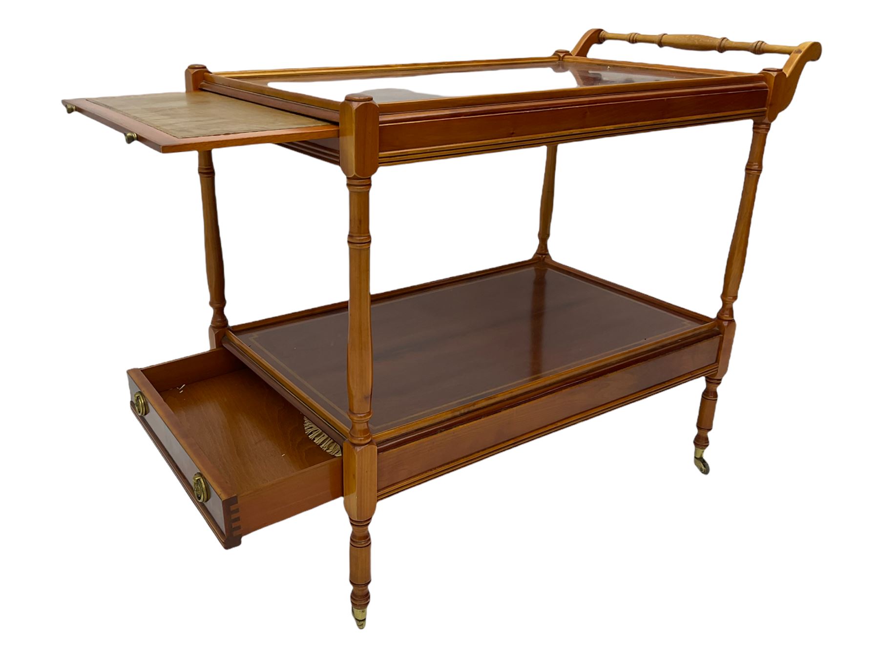 Yew wood drinks trolley, rectangular form with leather inset slide and turned handle, the undertier fitted with drawer, turned supports and brass castors