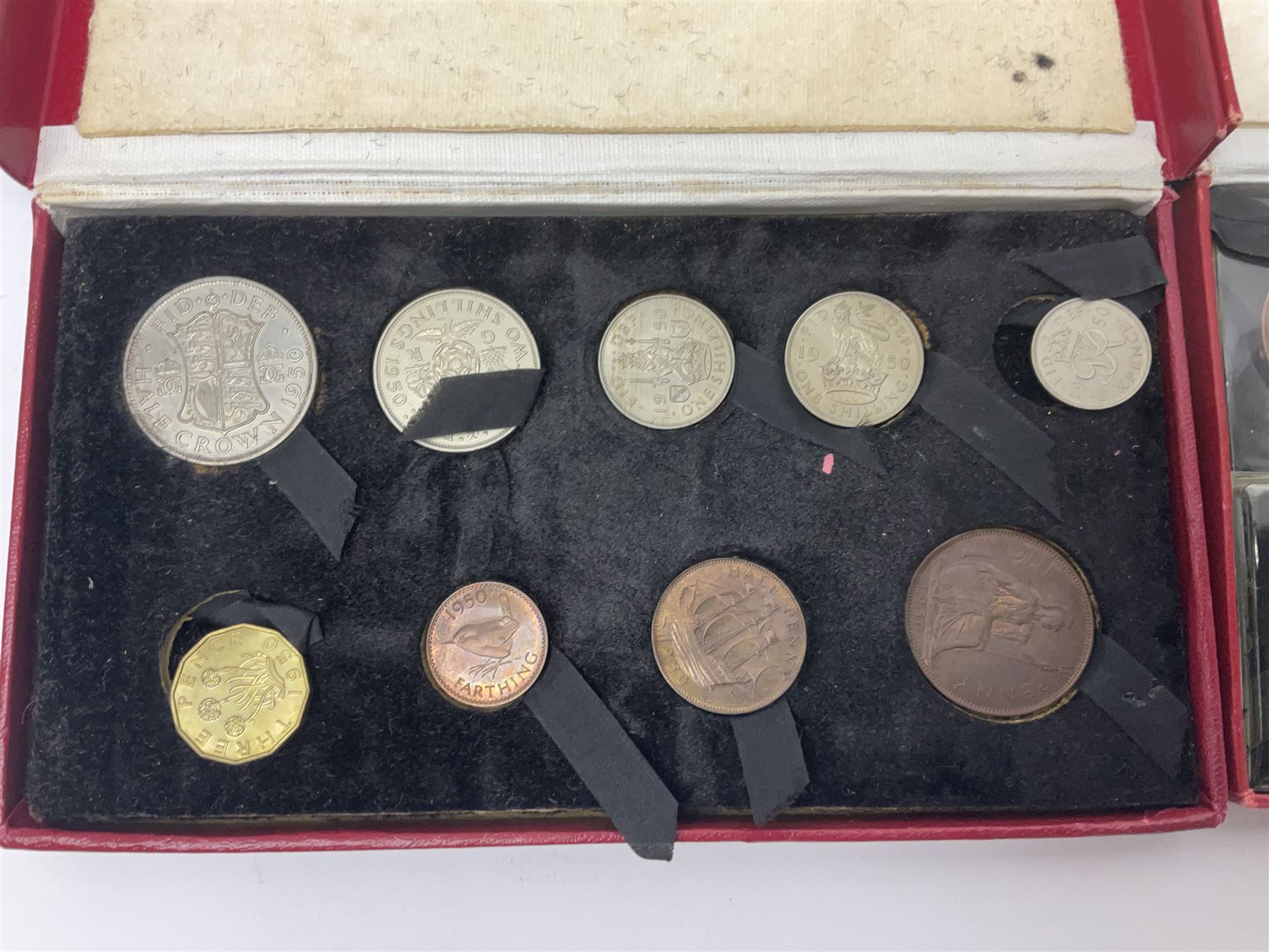 Four King George VI 1950 specimen coin sets, each comprising farthing, half penny, penny, threepence, sixpence, English  one shilling, Scottish one shilling, two shillings and half crown, each in red Royal Mint card case