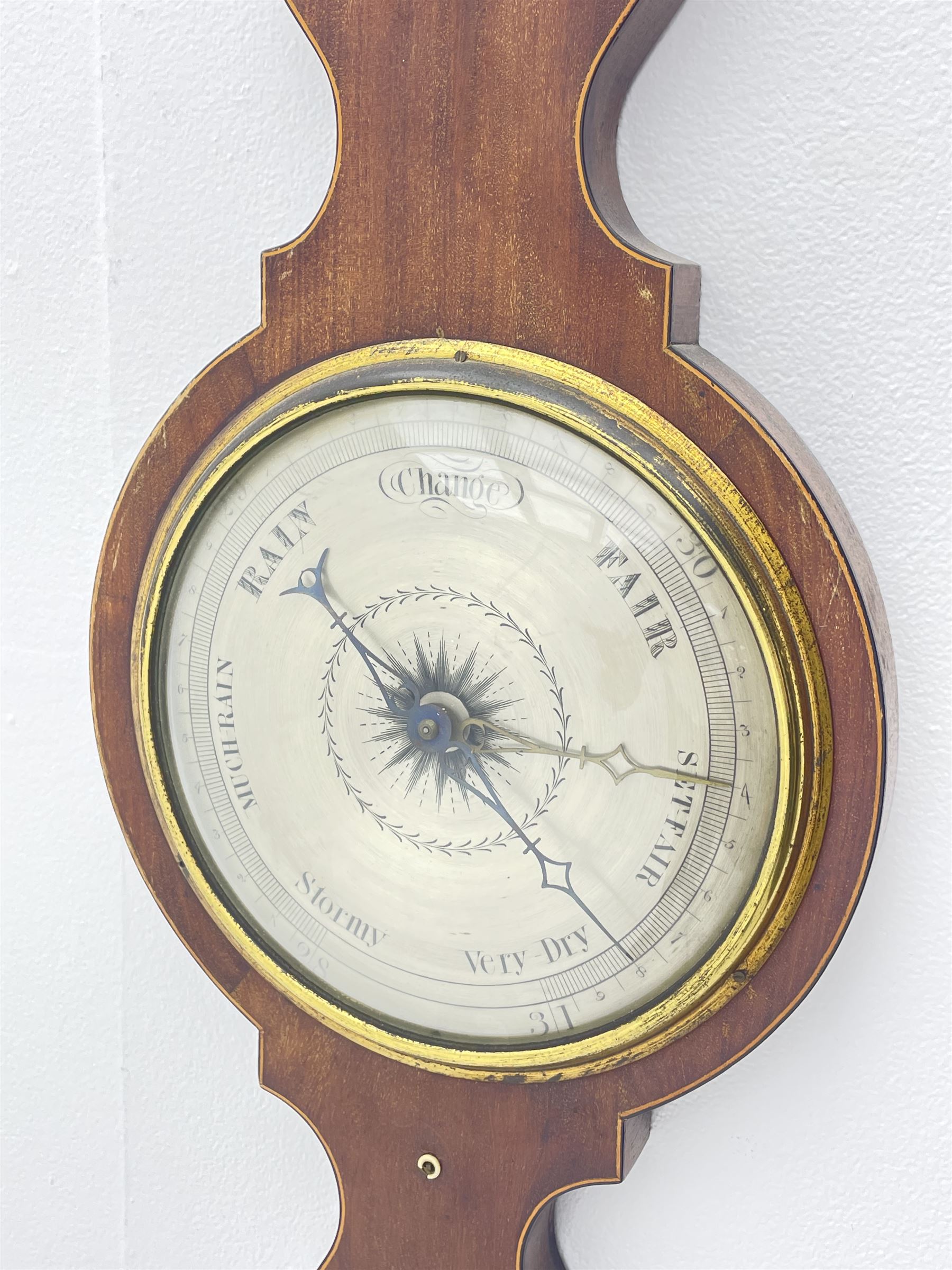 Early 19th century mahogany banjo barometer, scroll pediment over dry/damp and thermometer dials with brass registers, by ‘Crowden & Garrod, London’ (H107cm), and an early 20th century walnut and satinwood banded barometer by ‘Aitchison, London’ (H96cm)