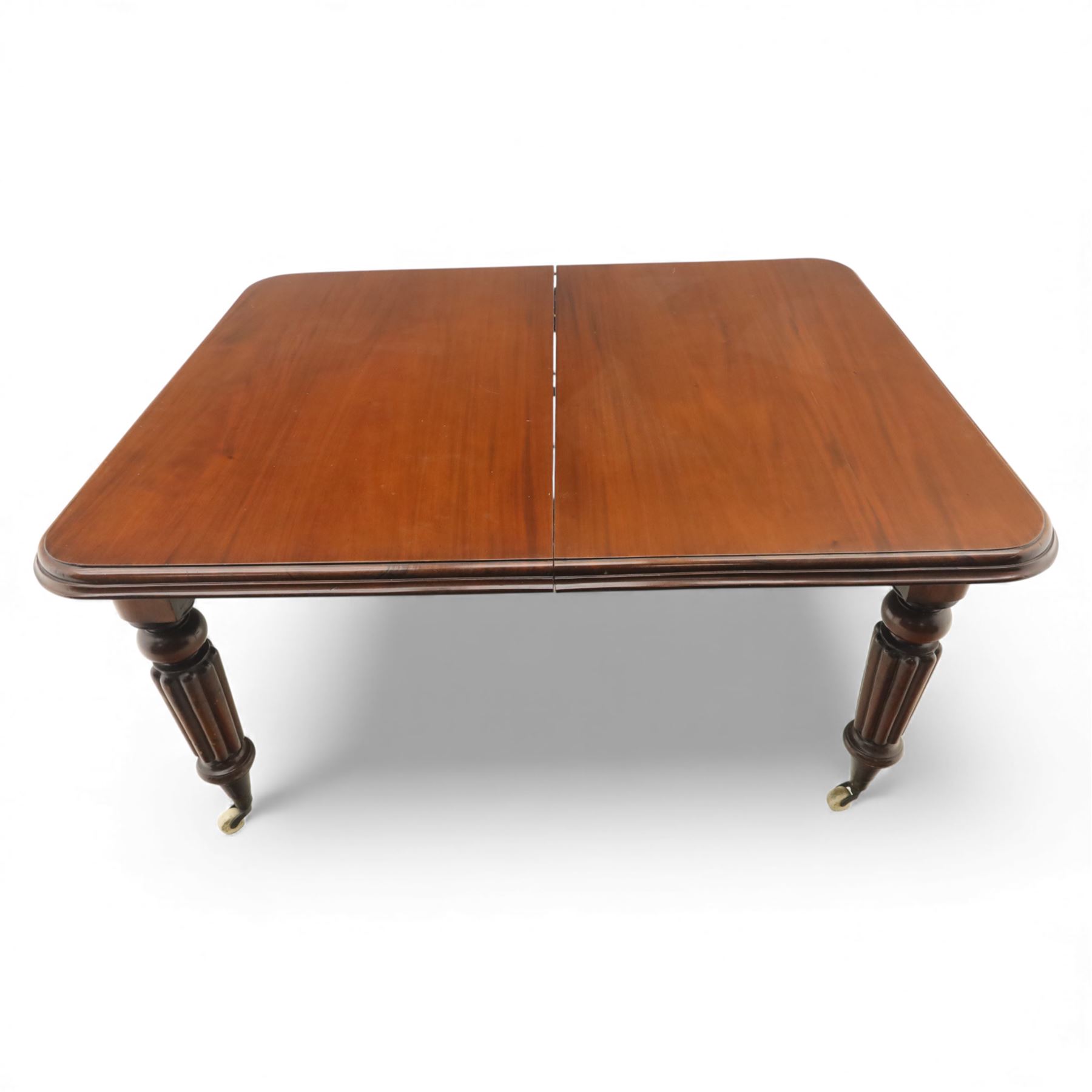 Large Victorian mahogany dining table, rectangular telescopic top with two additional leaves, upon turned knopped and reeded legs with ceramic casters, (Extends to 230cm)