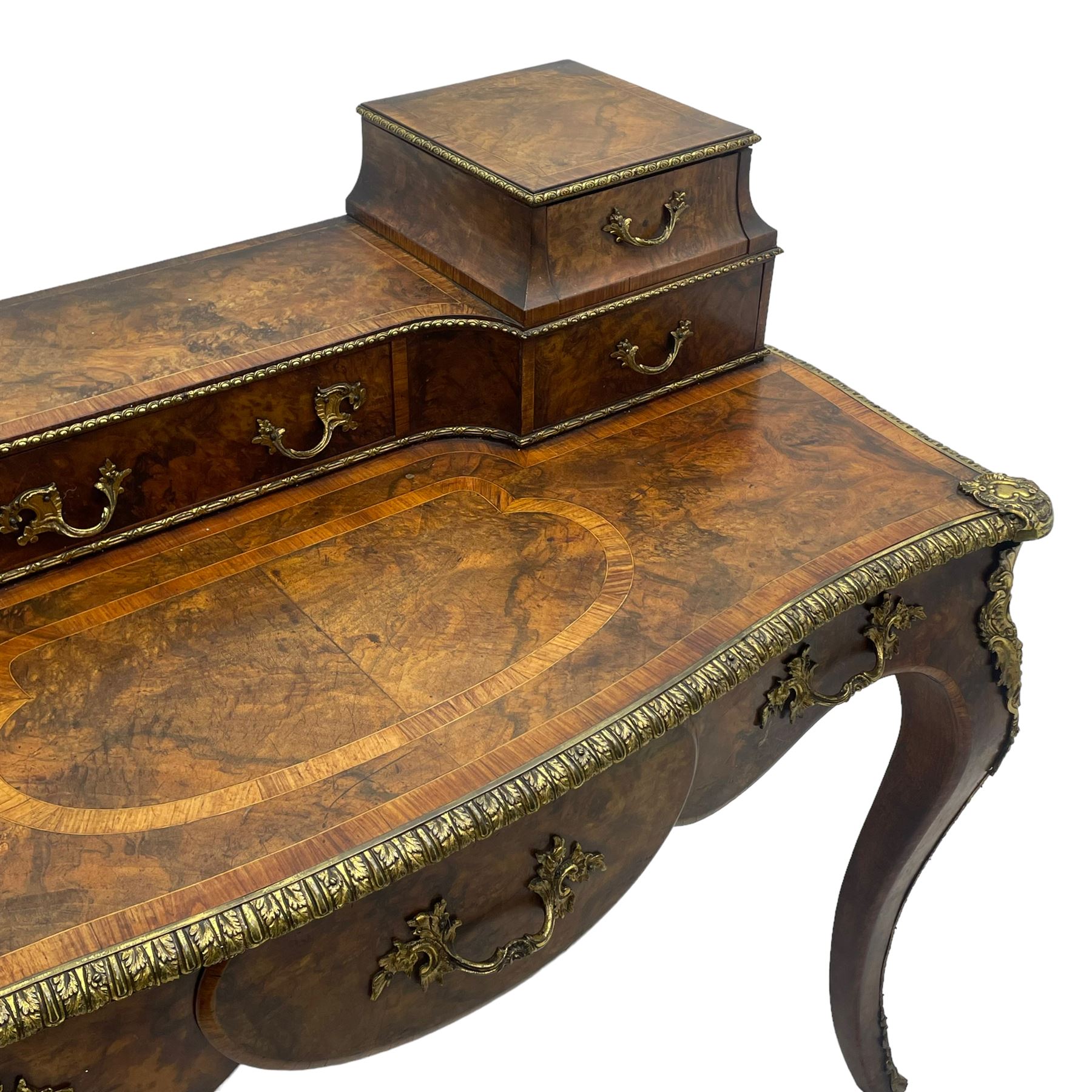 Late 19th to early 20th century French figured walnut writing desk, raised back fitted with drawers, shaped top with Kingwood banding and foliage cast edge moulding, fitted with single drawer, on cabriole supports mounted by shell and flower head cartouches 