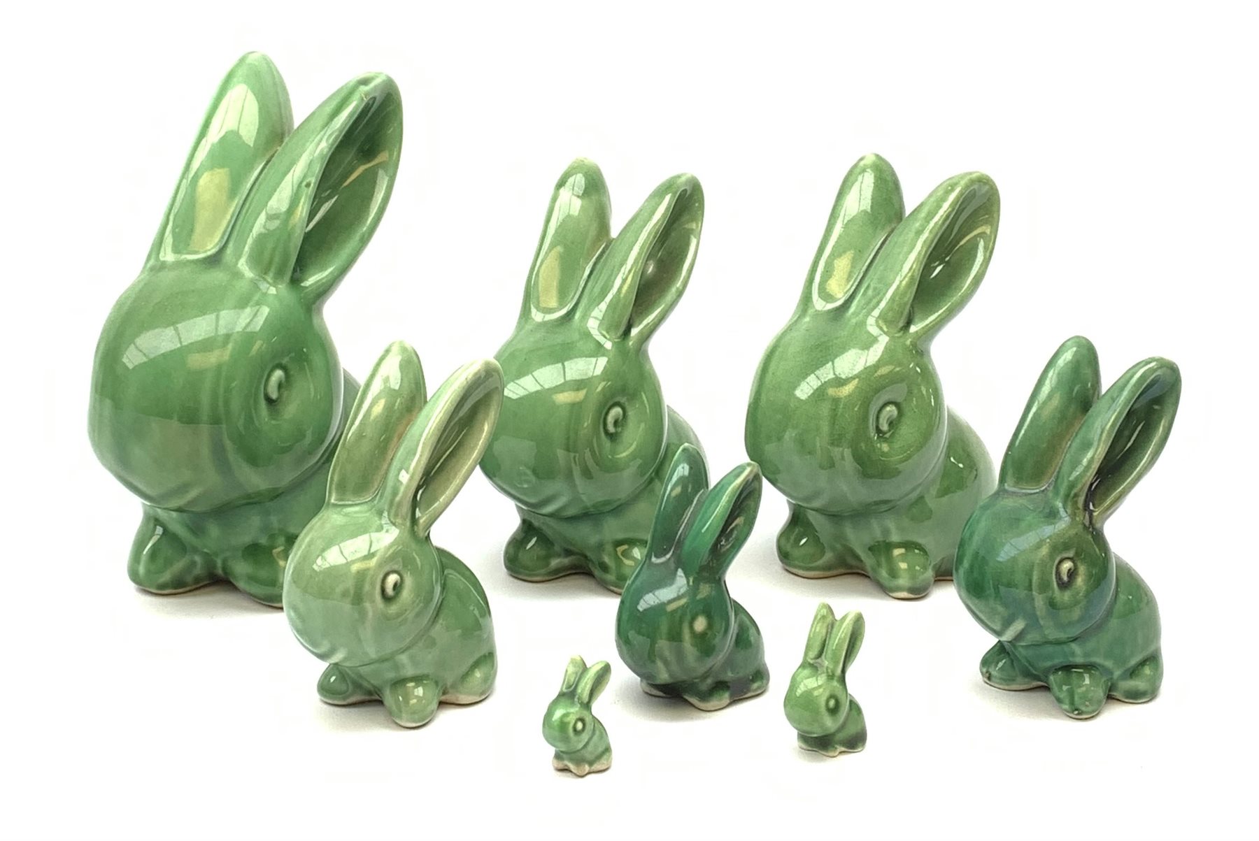 A collection of eight Denby green glazed models of the Rabbits Marmaduke and Cotton tail, various sized, largest H20.5cm, some marked. 