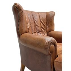 Tetrad - 'Blake' club armchair, fanned wingback and rolled arms upholstered in tan brown leather, on ball and claw carved cabriole feet 
