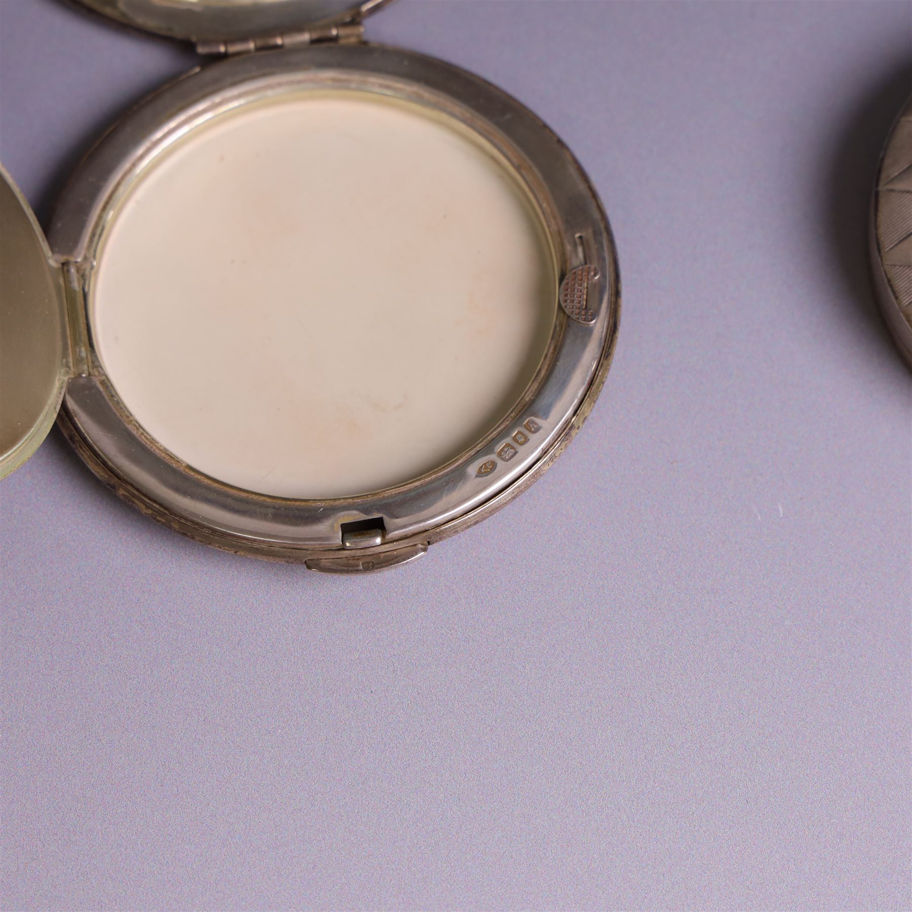 Two silver circular compacts, including Continental 800 silver example with geometric decoration, stamped 800 and a Kigu example with engine turned concentric circle decoration, hallmarked Kigu Ltd, London 1963, largest D7.5cm