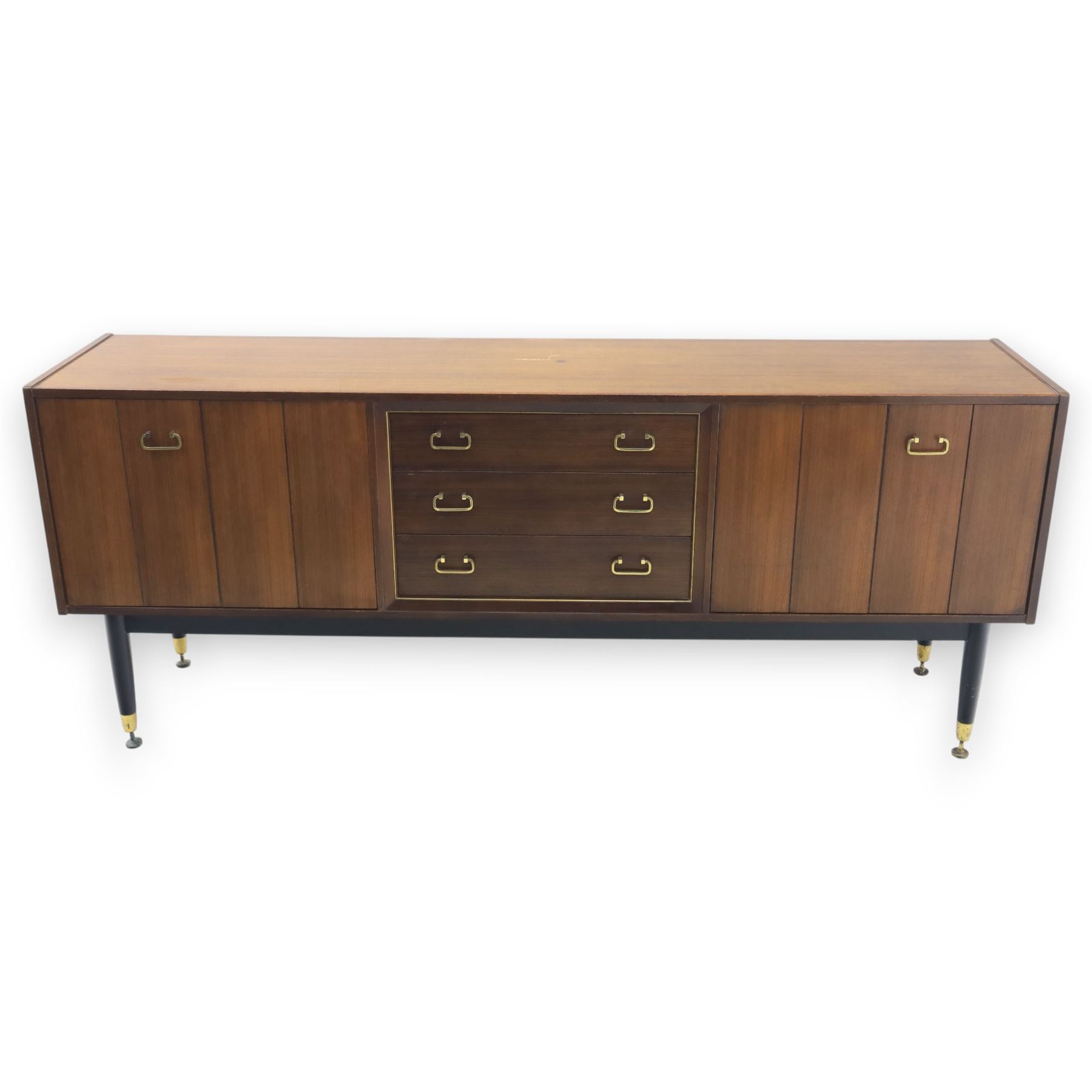 G Plan - ‘Librenza’ tola wood sideboard, the rectangular top above two cupboards to either side and three graduated central drawers, the drawer and door fronts veneered in figured tola wood with brass handles, standing on splayed tapering legs