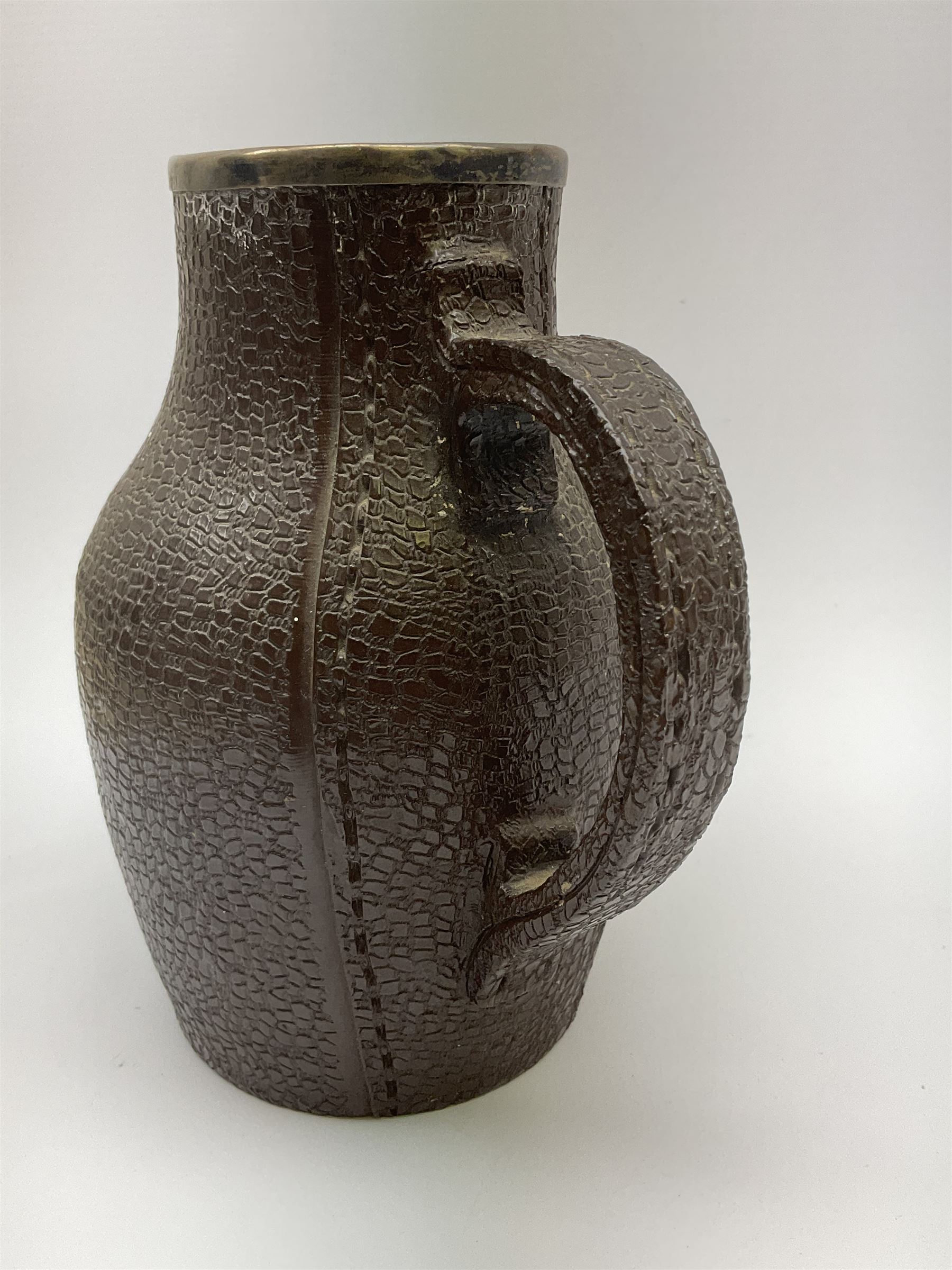 A Doulton Lambeth stoneware jug, with silver mounted collar, hallmarks rubbed, maker's mark probably Cornelius Desormeaux Saunders & James Francis Hollings (Frank) Shepherd, the leather effect body titled 'Drinke Faire Don't Sware', with impressed marks beneath including 'Manufactured for Sidney W Allen 39 White Rock Hastings', H18.5cm. 