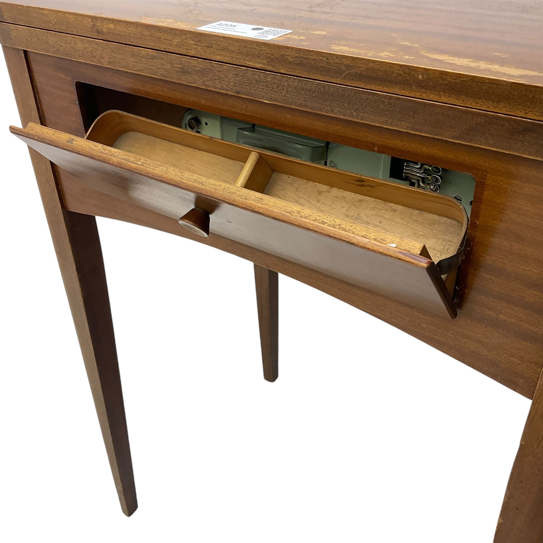 Mid-20th century teak sewing table, rectangular top with hinged fold-out extension revealing built-in Singer sewing machine, fitted with single hinged drawer, on square tapered supports; various Singer accessories to include Fashion Discs and Motor Controller