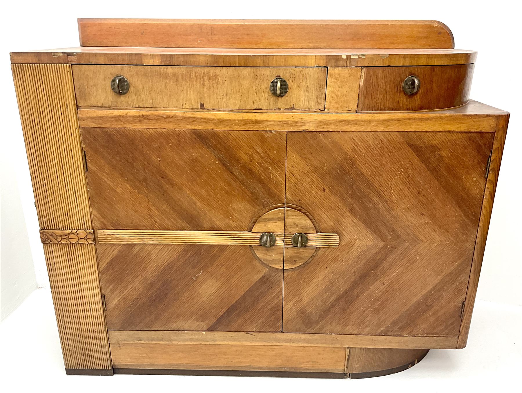 Art Deco oak sideboard, raised shaped back, two drawers above two cupboards, platform base