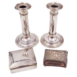 Pair of early 20th century silver mounted candlesticks, each if typical form with stepped sconces and weighted circular base, hallmarked S Blanckensee & Son Ltd Chester 1911, together with a 1920s silver mounted cigarette box, hallmarked Chester 1929, maker's mark indistinct, and a Victorian silver mounted matchbox holder, with embossed scrolling decoration, hallmarked James Deakin & Sons, Chester 1897, candlesticks H16cm