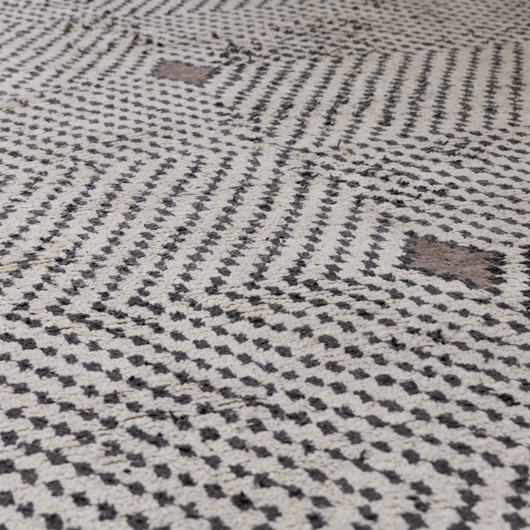 Contemporary Beni Ourain style wool rug, woven with a cream field and dark brown geometric chevron lattice, centred by repeating small diamond medallions, with short fringe ends