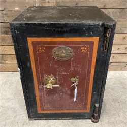 Samuel Withers & Co of West Bromwich - Victorian cast iron safe, the brass handle modelled as a clenched fist, painted in red, orange and black, with key. Ground floor delivery only, no steps.