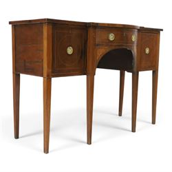 Regency period inlaid mahogany bow-breakfront sideboard, shaped rectangular top with crossbanding and ebony stringing, central convex frieze drawer flanked by cupboard and cellarette drawer, over fan-inlaid spandrels, raised on square tapering supports