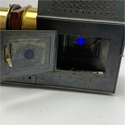 Victorian French brass and black japanned magic lantern inscribed  'Lanterne Depose C. & G. P. Universelle', with two hinged doors to the sides of the burner housing, L43cm (lacking burner)