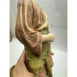 Pair of Royal Dux figures, no. 1115, modelled as a shepherd with a goat by his side and a shepherdess feeding a lamb, each wearing flowing green and pink robes with gilt detailing, with pink triangle mark beneath, H51cm